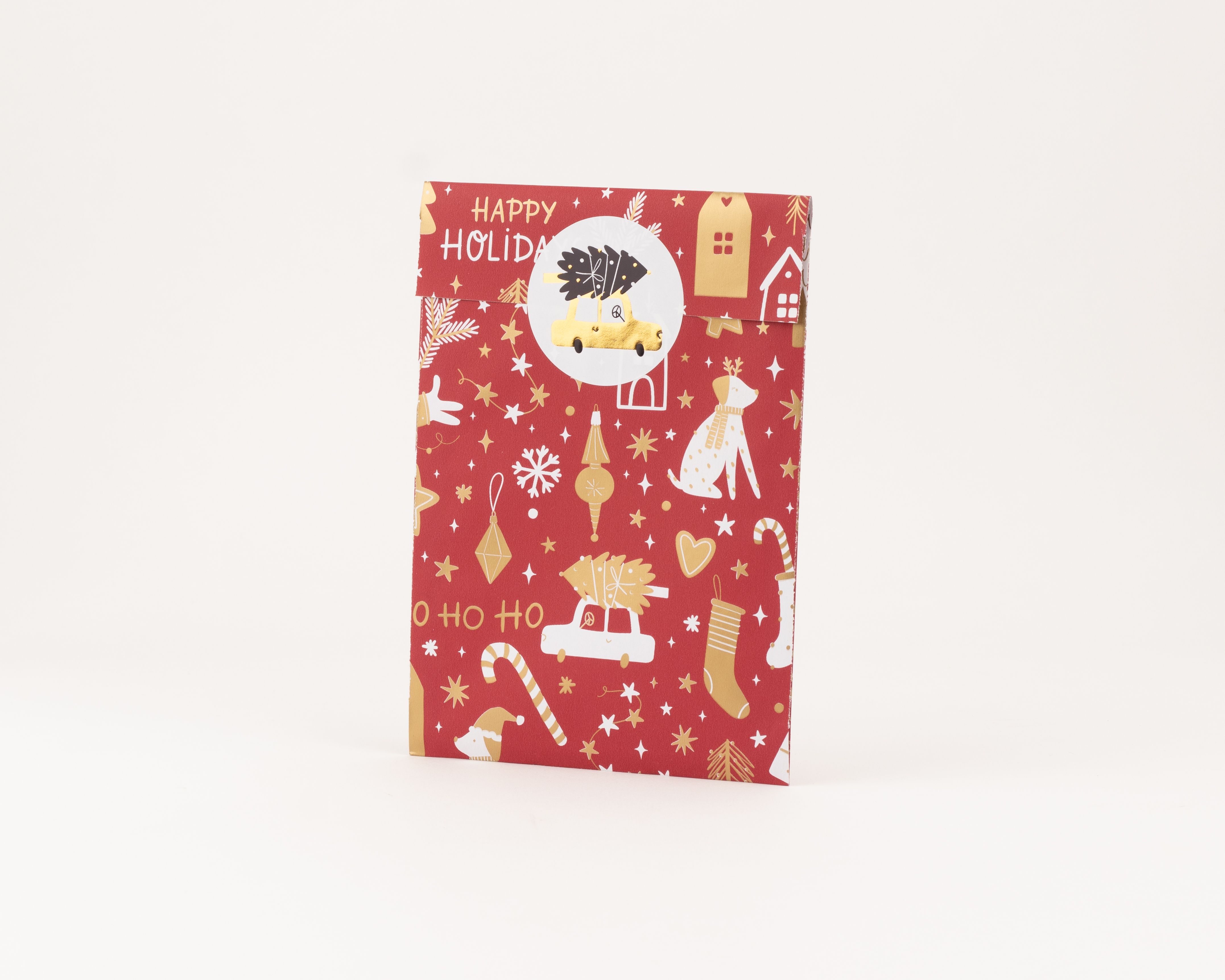 Flachbeutel mit rotem Weihnachtsmotiv in Gold und Weiß, zeigt festliche Fahrzeuge, Sterne und Text. Die Innenseite ist goldfarben