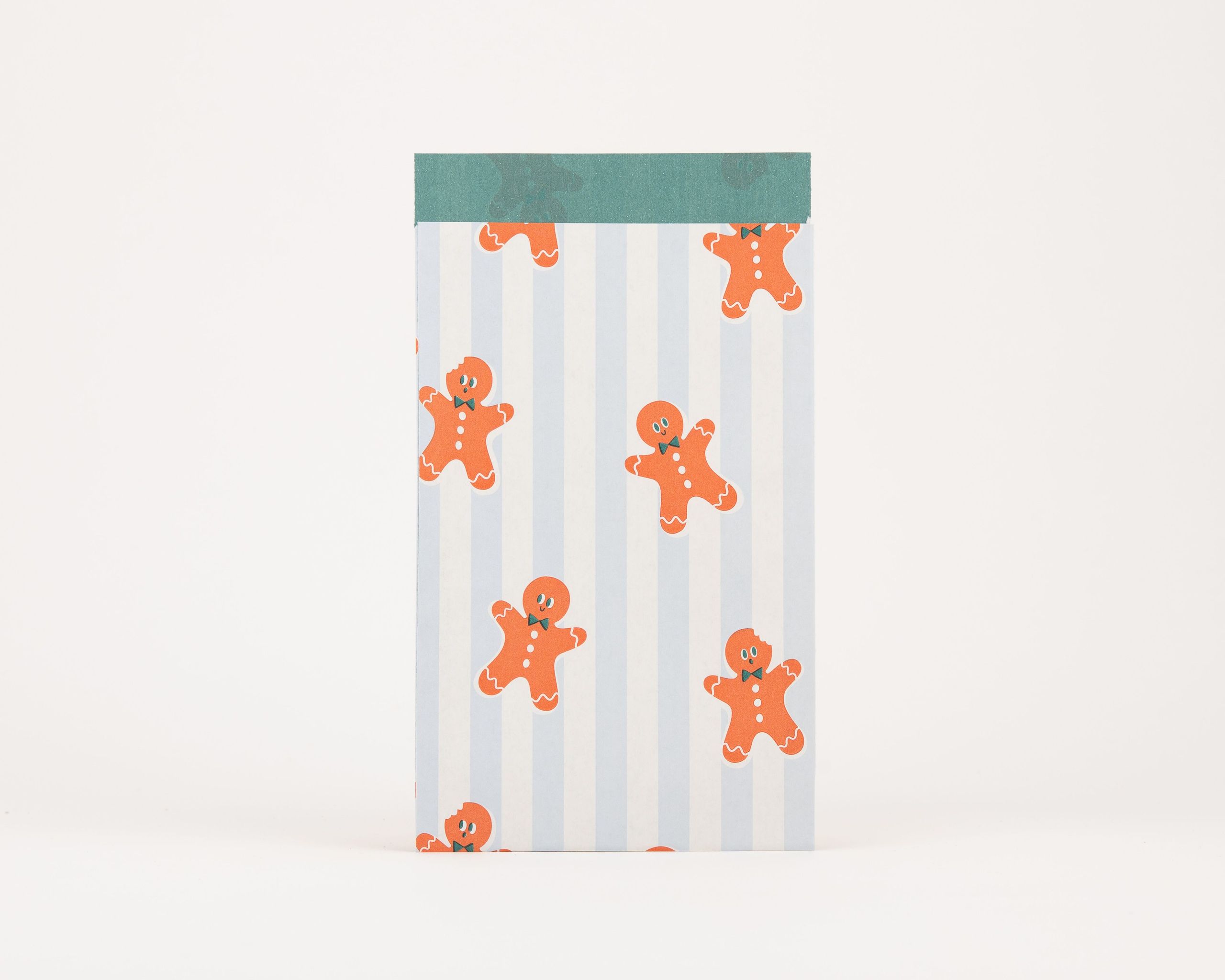 Papiertüten Flachbeutel mit einem blau-weiß gestreiften Muster und orangefarbenen Lebkuchenmännchen. Die Innenseite ist in Grün gehalten