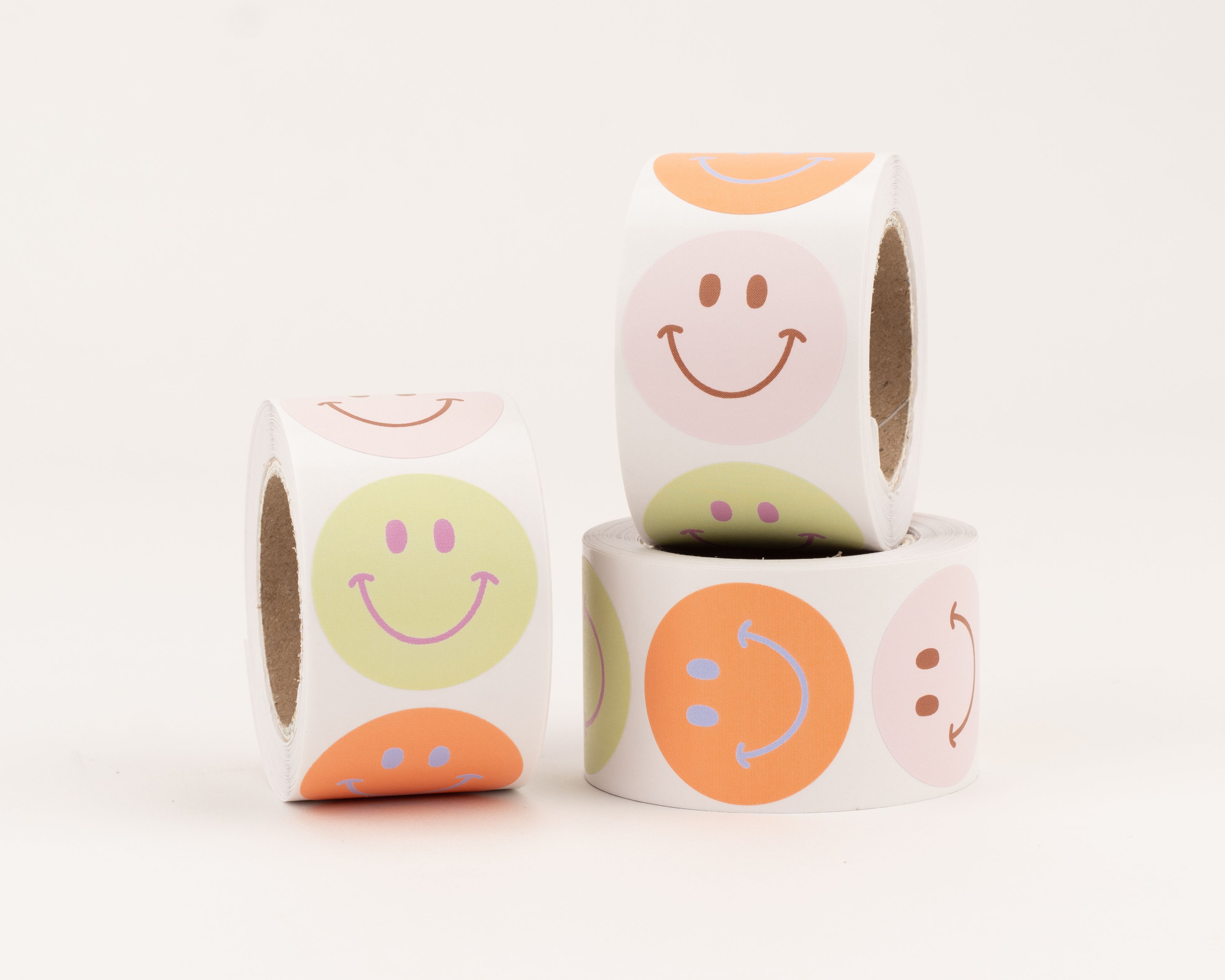 Aufkleber mit fröhlichen Smileys in verschiedenen Farben, darunter grüne, orangefarbene und rosa Sticker mit unterschiedlichen Gesichtsausdrücken