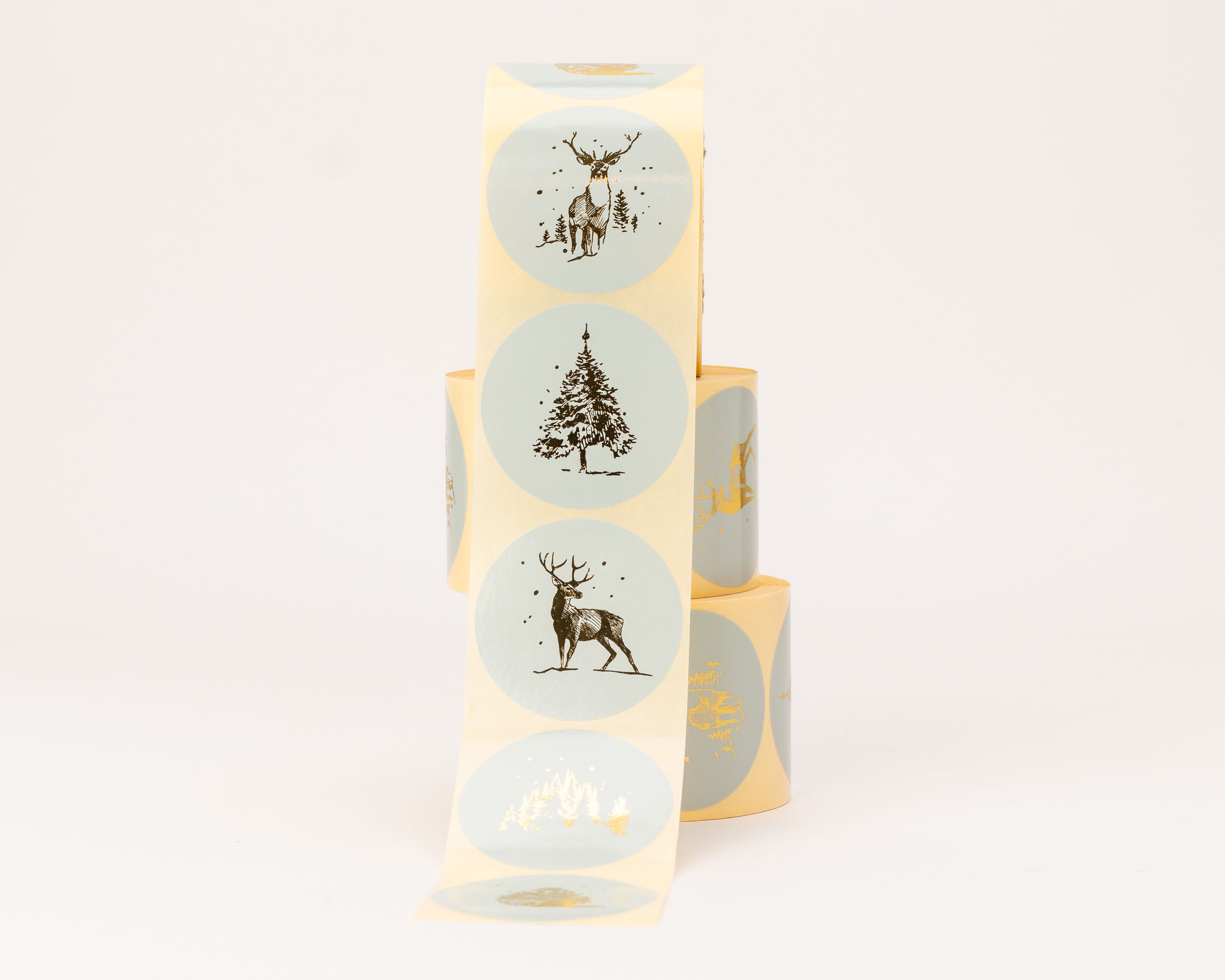 Aufkleber mit verschiedenen Skandi Weihnachtsmotiven, darunter Hirsche, Tannenbäume und Waldlandschaften, in Blau und Gold-Effekt