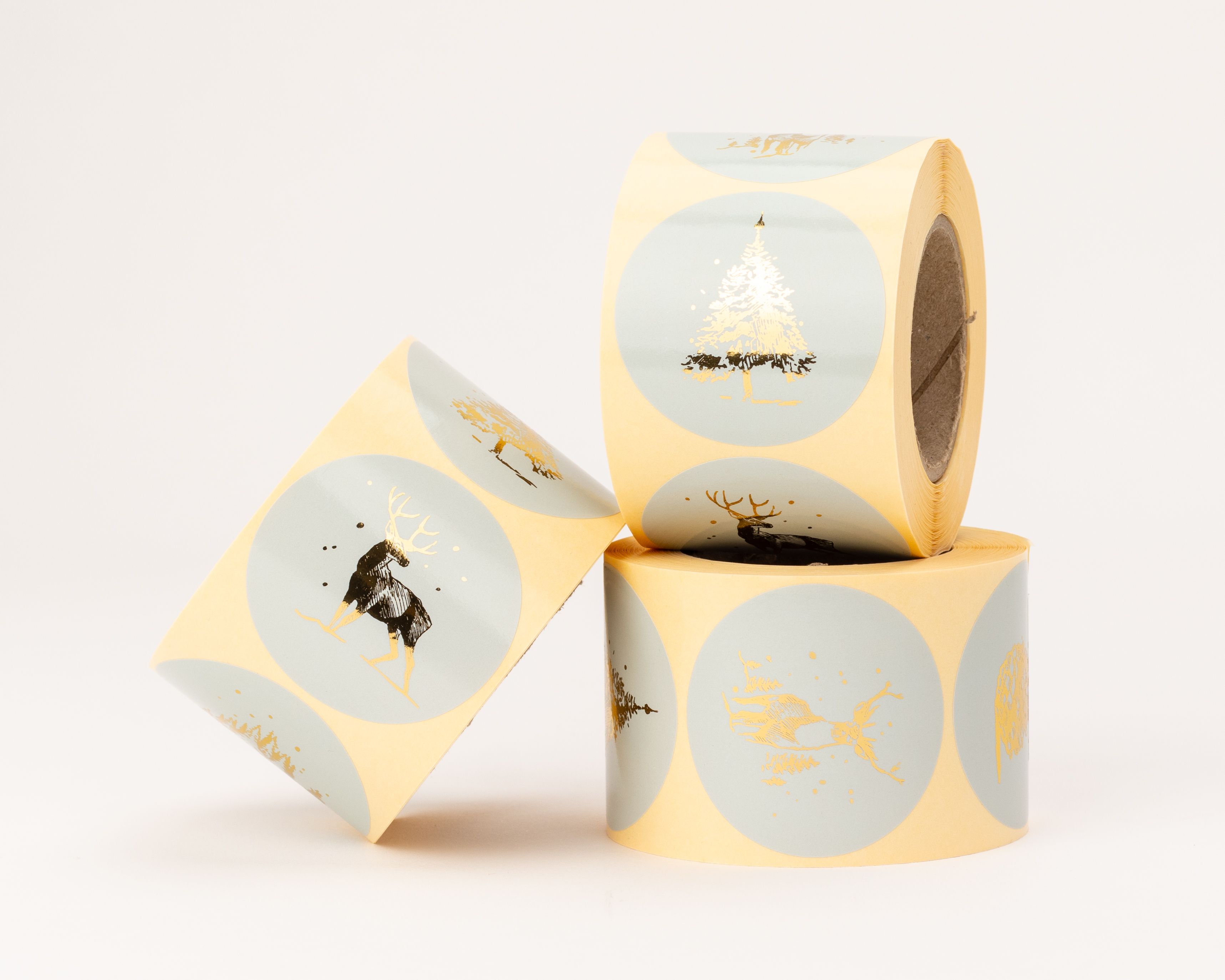 Aufkleber mit verschiedenen skandinavischen Weihnachtsmotiven in Blau und glänzendem Gold-Effekt, darunter Hirsche und Tannenbäume