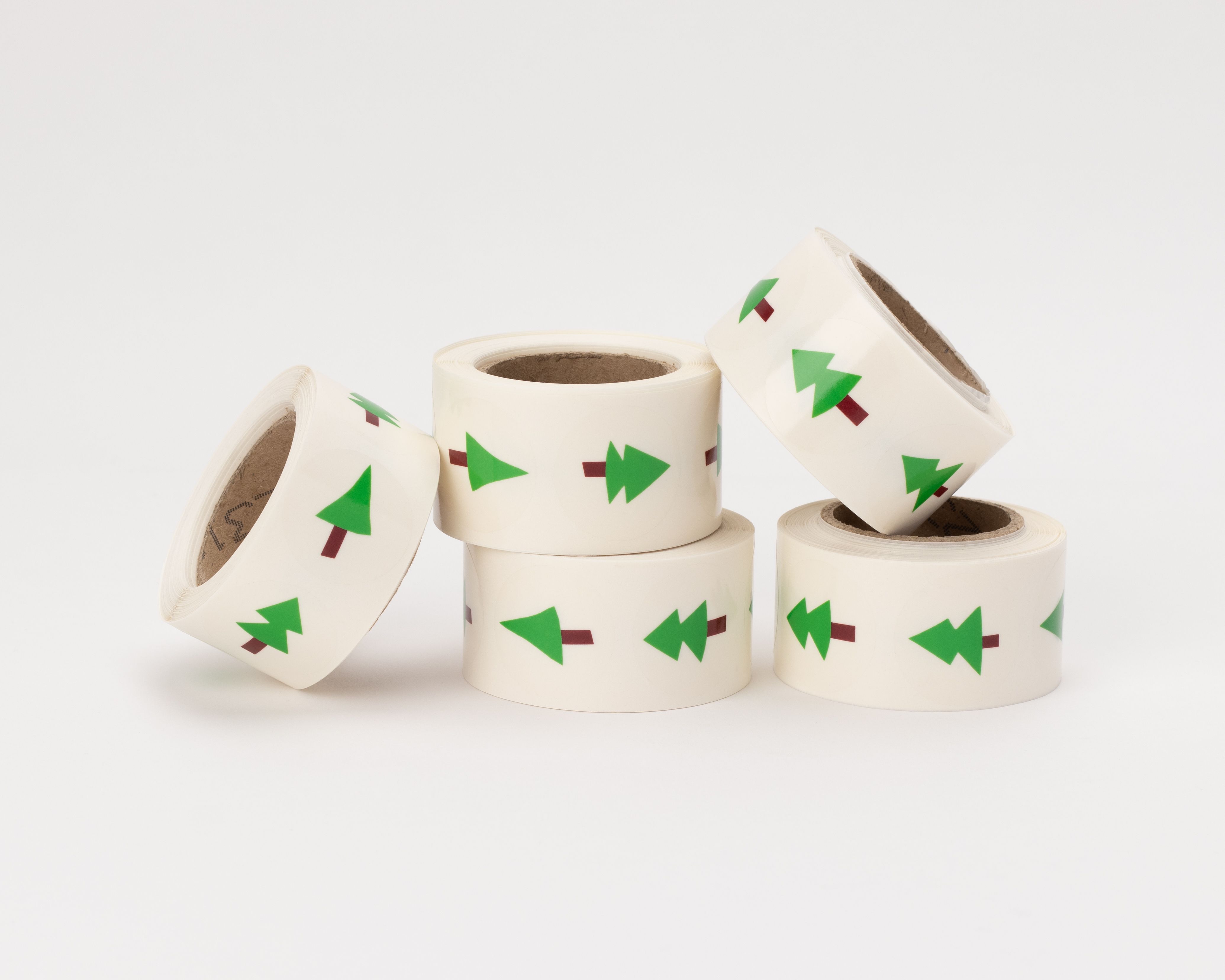 Aufkleber mit grünem Tannenmotiv und braunem Stamm auf transluzentem Hintergrund, präsentiert als Sammlung von Stickern