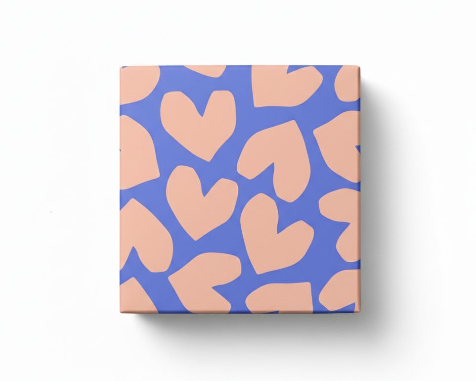Geschenkpapier mit blauem Hintergrund und pfirsichfarbenen Herzen, als quadratisch verpacktes Geschenk von oben dargestellt