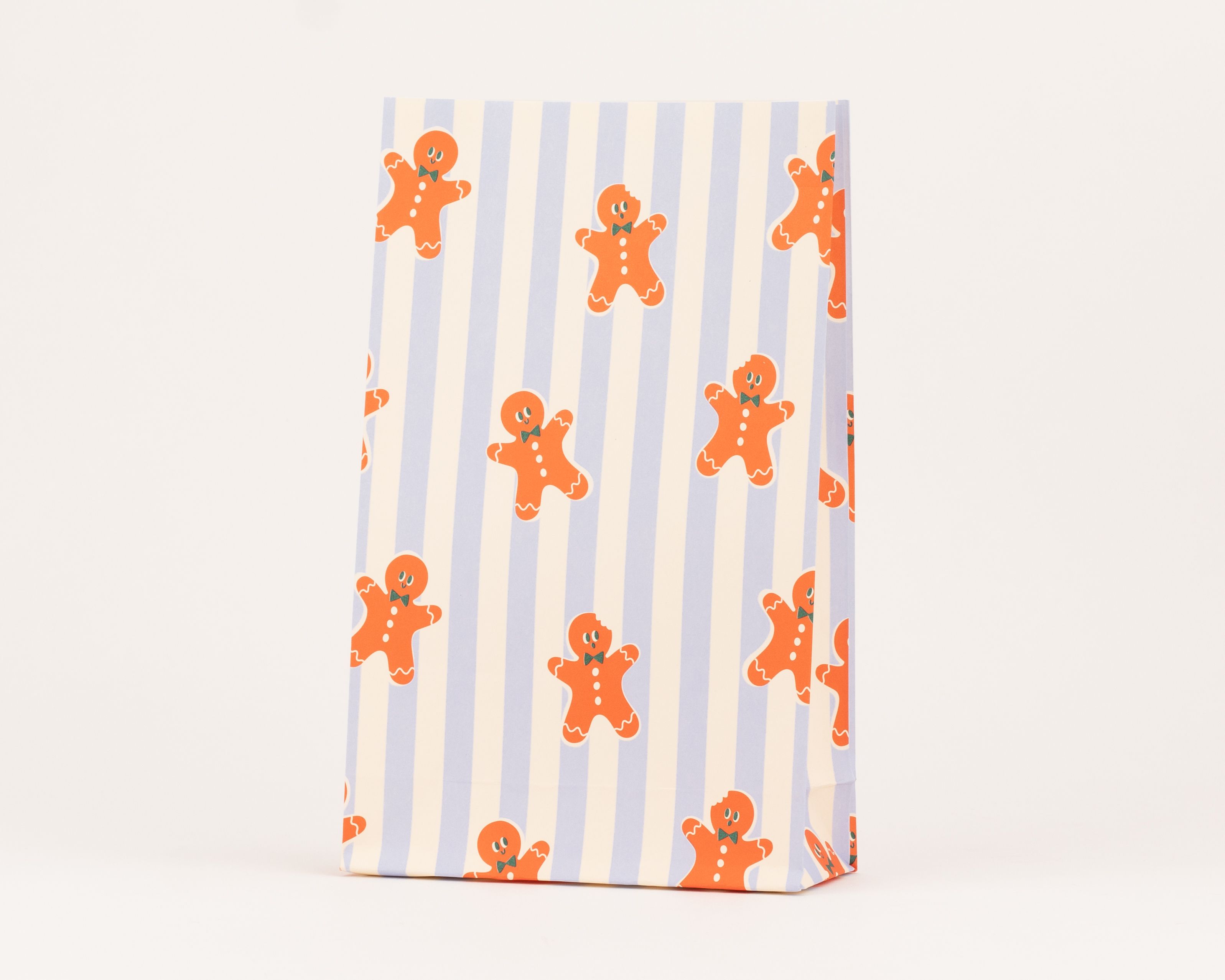 Blockbodenbeutel mit vertikalen Streifen in Blau und Elfenbein sowie aufgedruckten orangen Lebkuchenmännchen