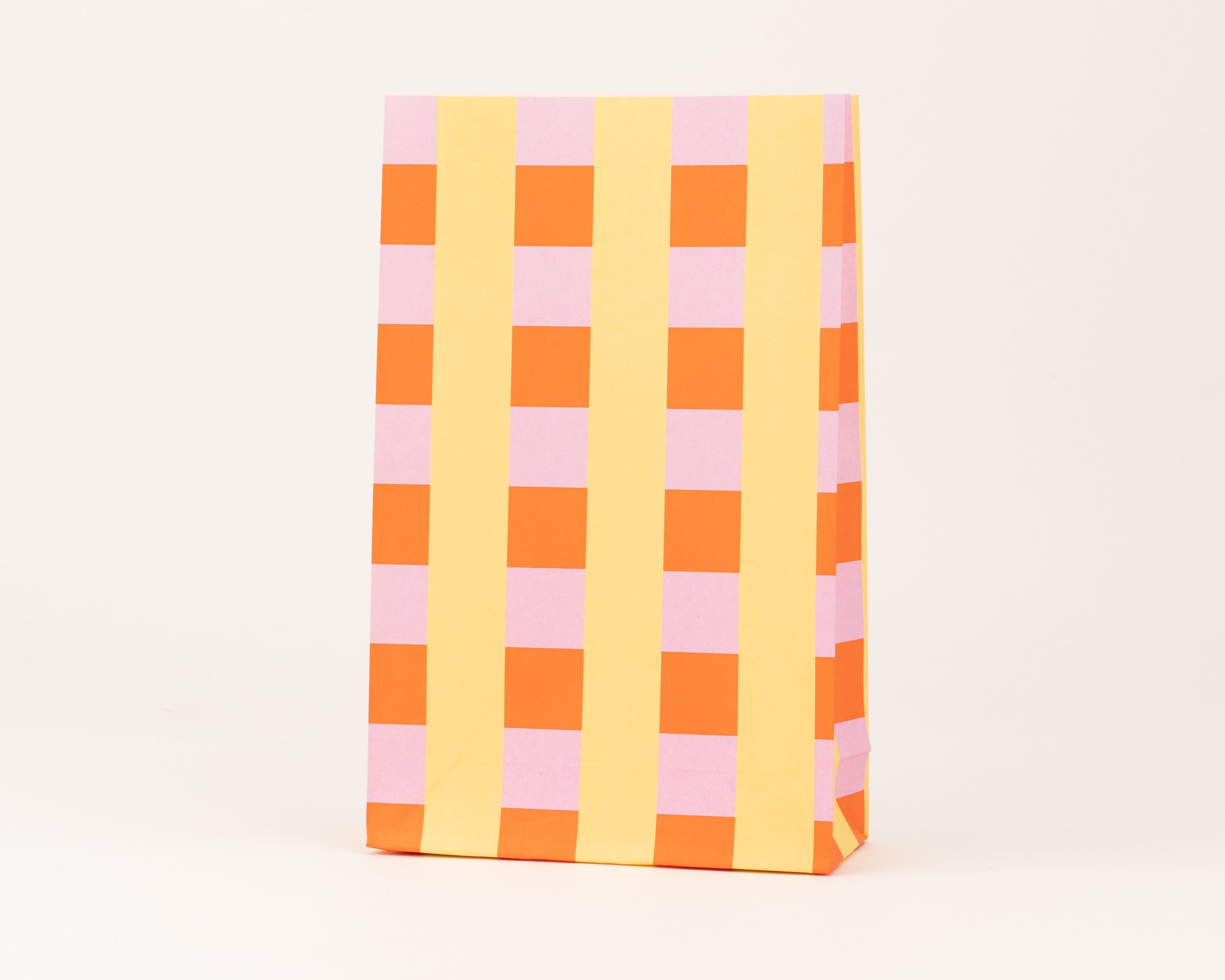 Papiertüten Blockbodenbeutel mit einem bunten Blockmuster in Mandarine, Rosa und Buttergelb