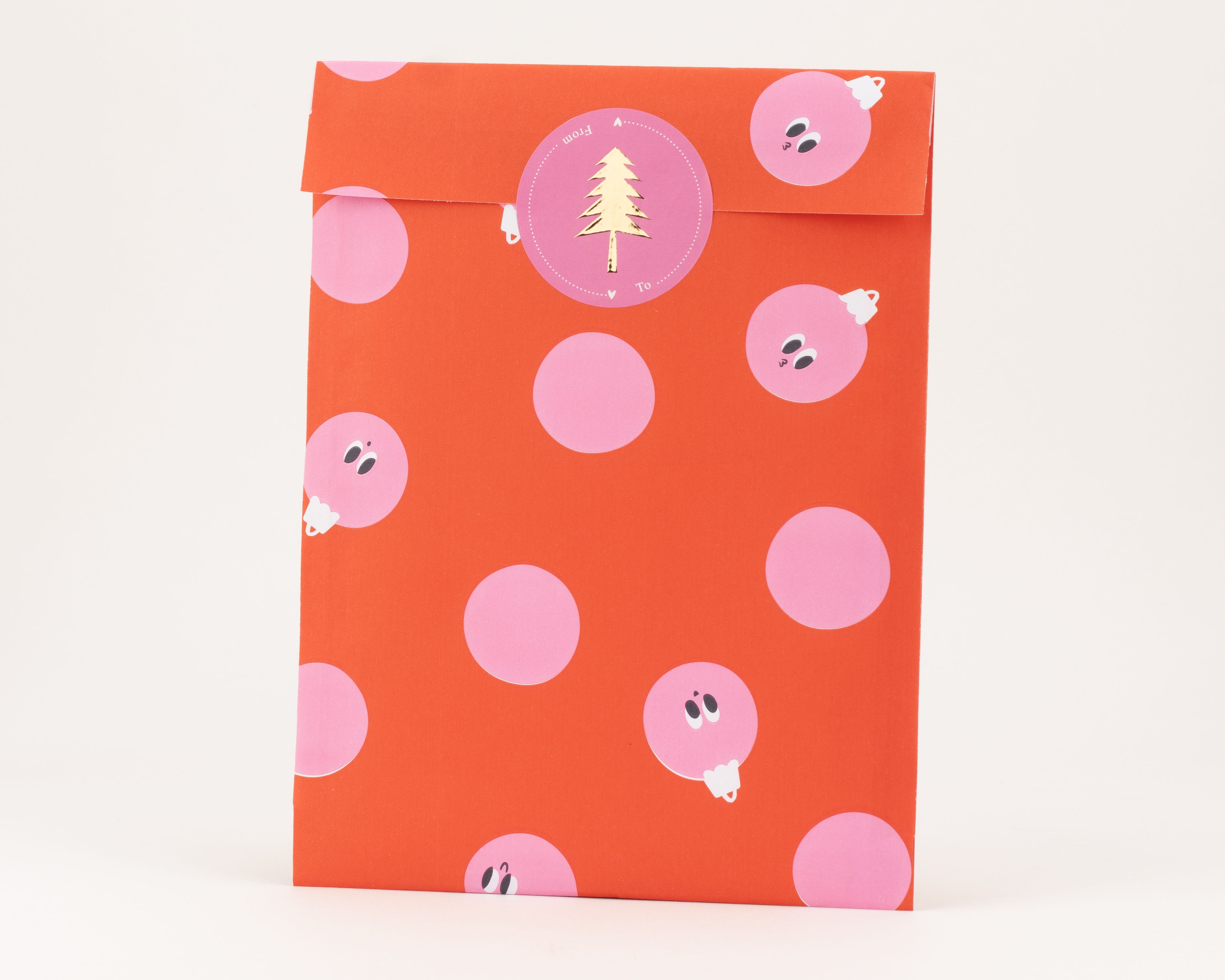 Flachbeutel mit rotem Hintergrund und pinken Peek-a-Boo Baubles, einige davon mit lustigen Gesichtern