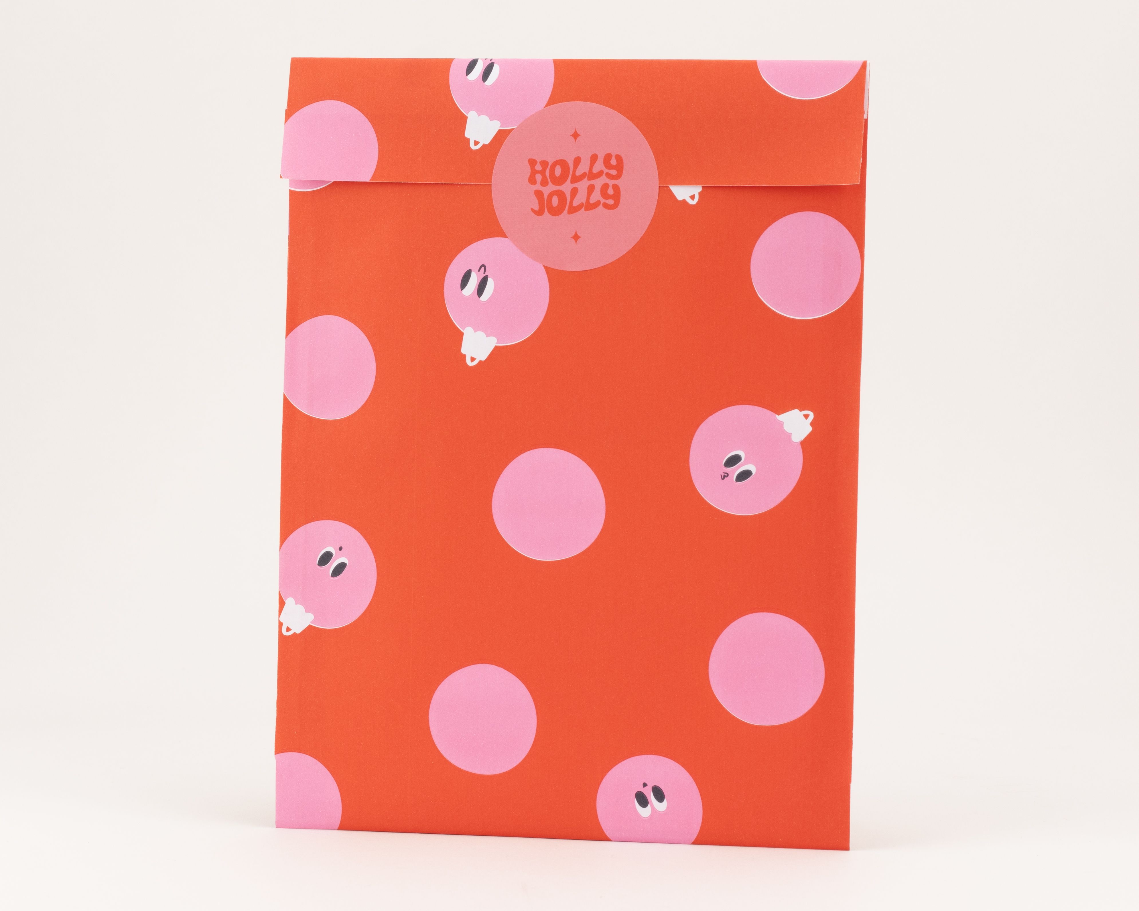 Flachbeutel mit rotem Grundton und einem Muster aus pinkfarbenen Kugeln, die Innenseite ist ebenfalls rot mit diesen Mustern