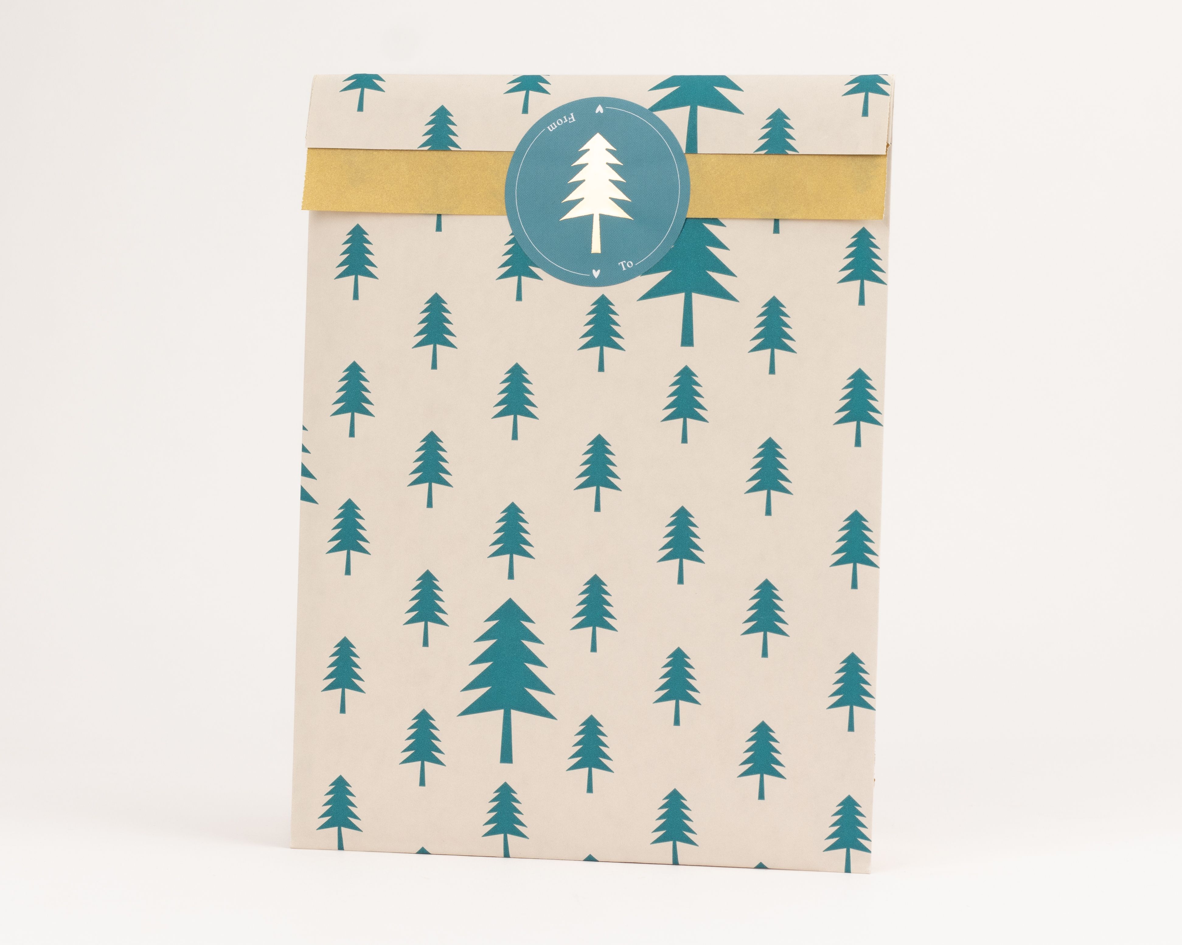 Flachbeutel mit beigem Grundton und einem durchgehenden Muster aus gruenen Tannenbaumen. Die Innenseite ist in einem hellen Gelbton gehalten