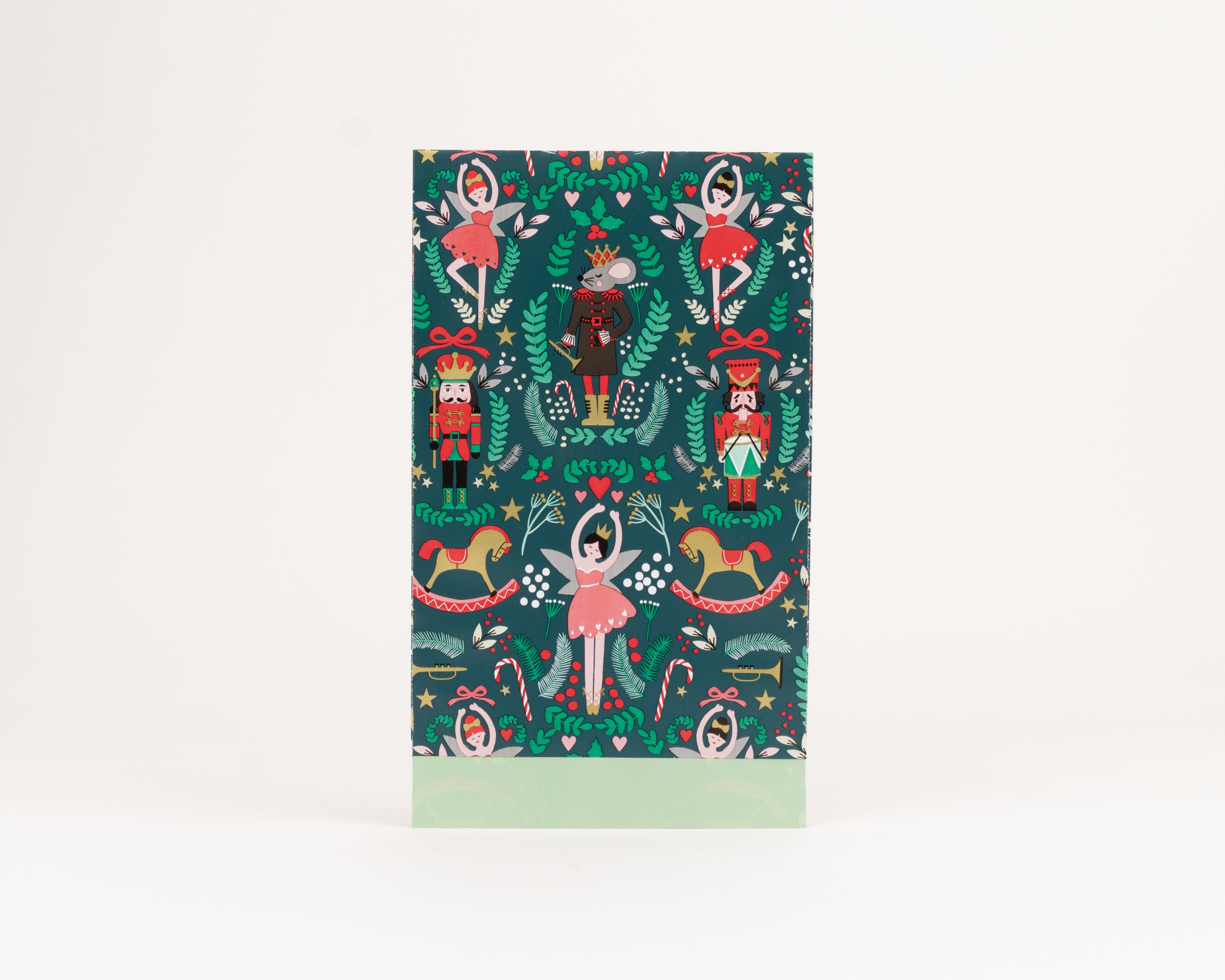 Flachbeutel mit dunkelgrünem Nussknacker-Weihnachtsmotiv aus Figuren und Ornamenten, die Innenseite ist hellgrün