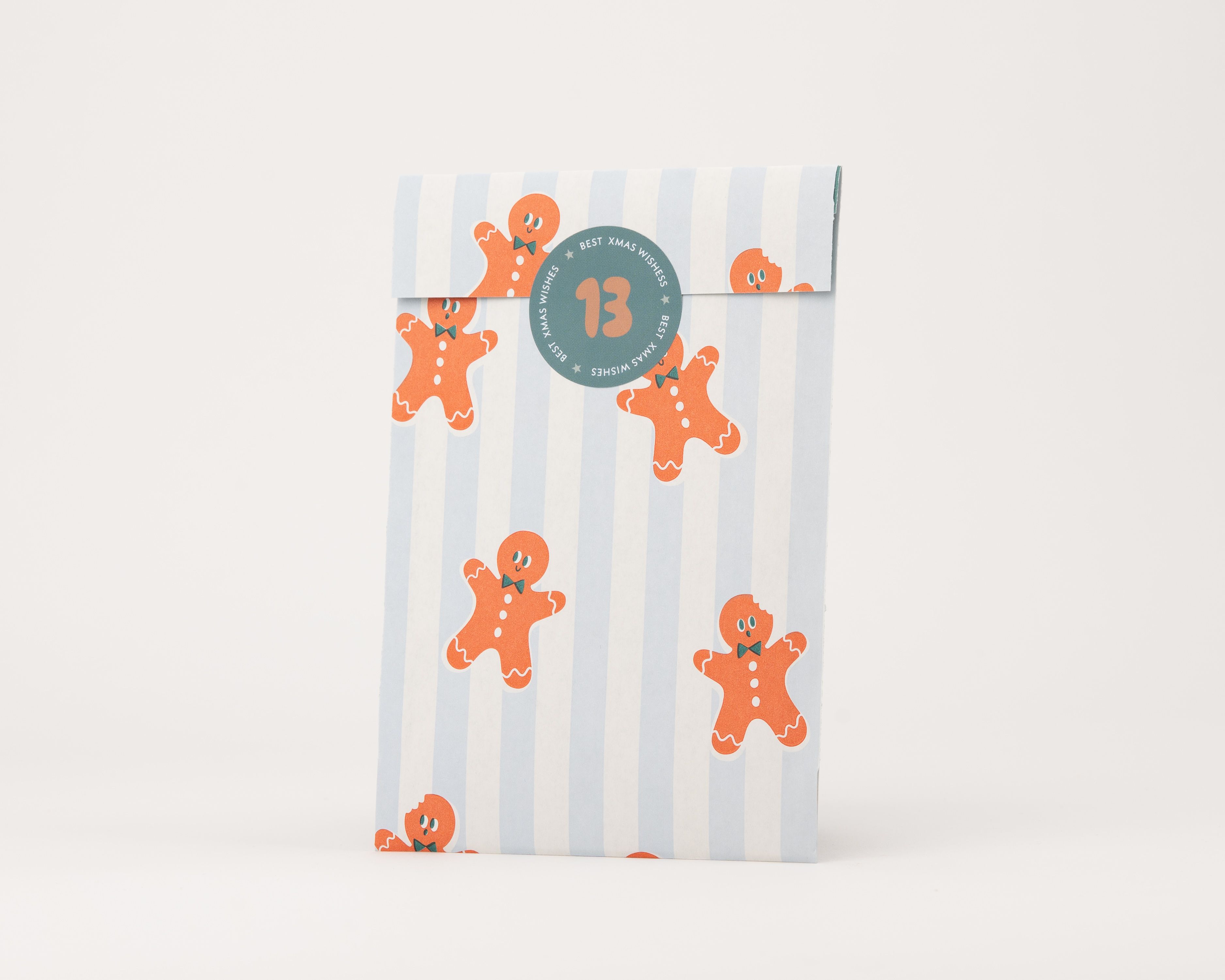 Papiertüten Flachbeutel mit blau-weißen Streifen, verziert mit orangefarbenen Lebkuchenmännchen und grünen Details