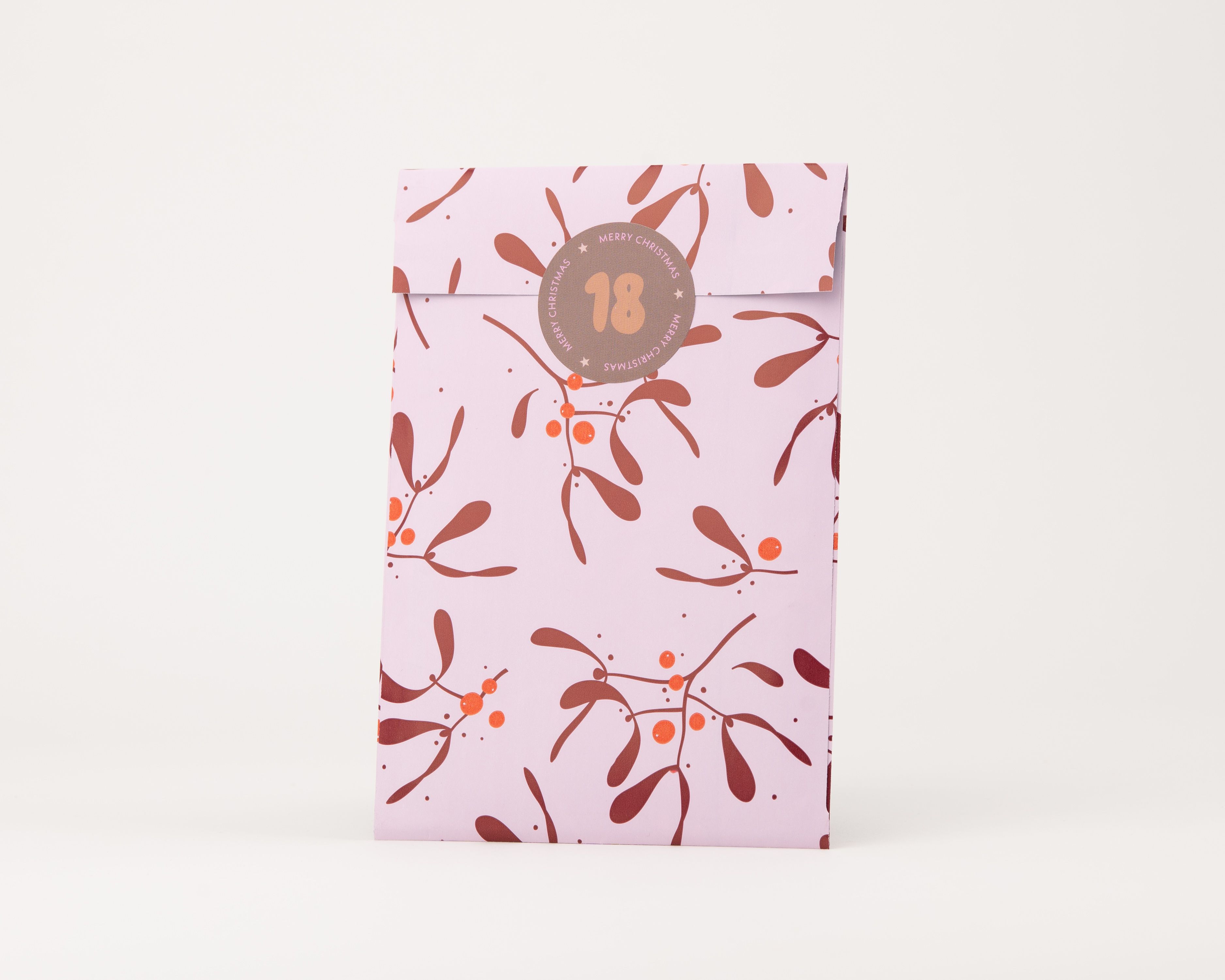 Papiertüten Flachbeutel in Hellrosa mit Weinrot- und Orange-farbenem Mistelzweig-Muster. Die Innenseite zeigt denselben hellrosa Farbton
