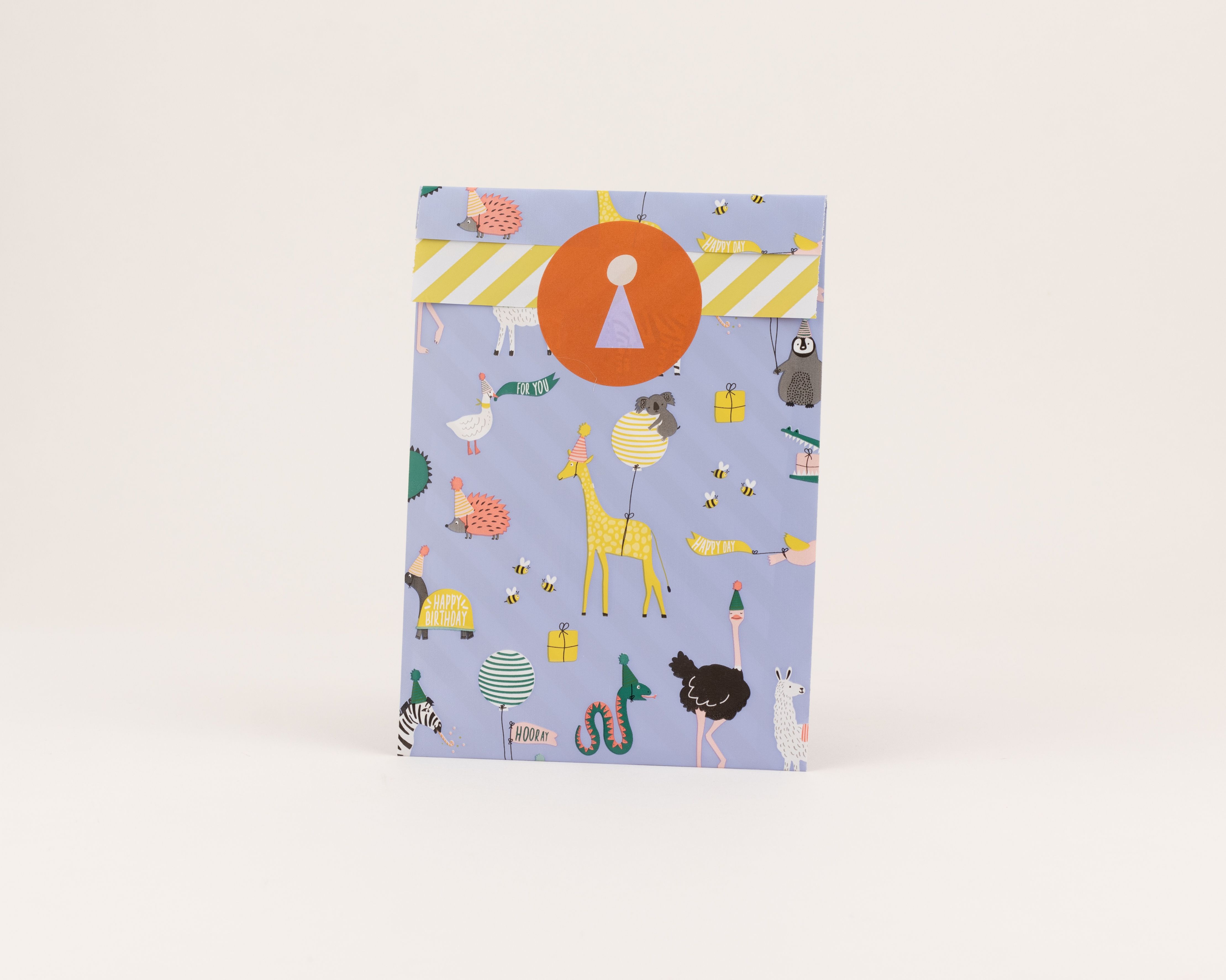 Flachbeutel mit blauem Hintergrund und einem Motiv aus Party-Tieren in Gelb und Grün. Die Innenseite zeigt gelb-weiße Streifen.