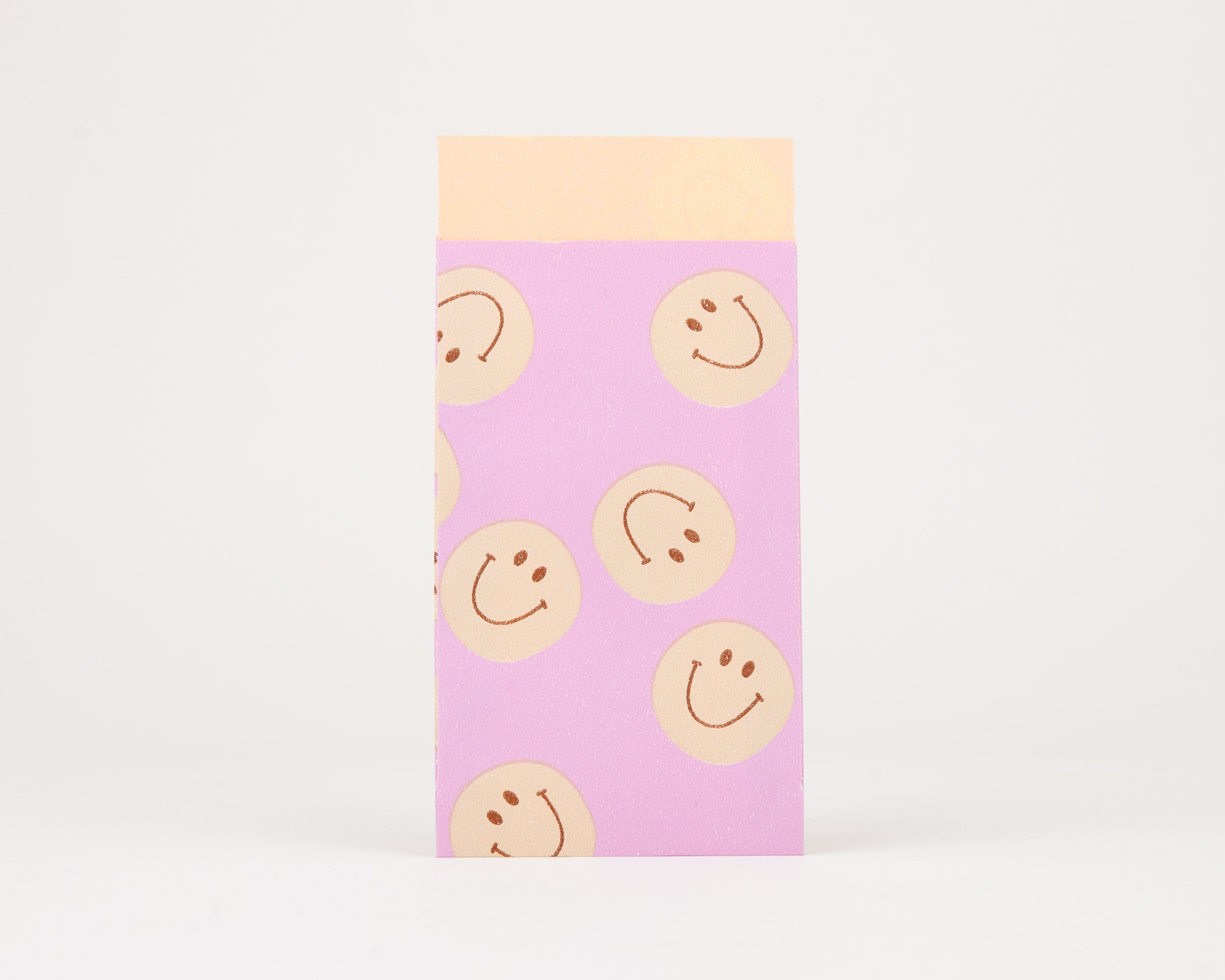 Papiertüten Flachbeutel in Flieder mit einem Muster aus orangefarbenen Smileys und einer orangefarbenen Innenseite