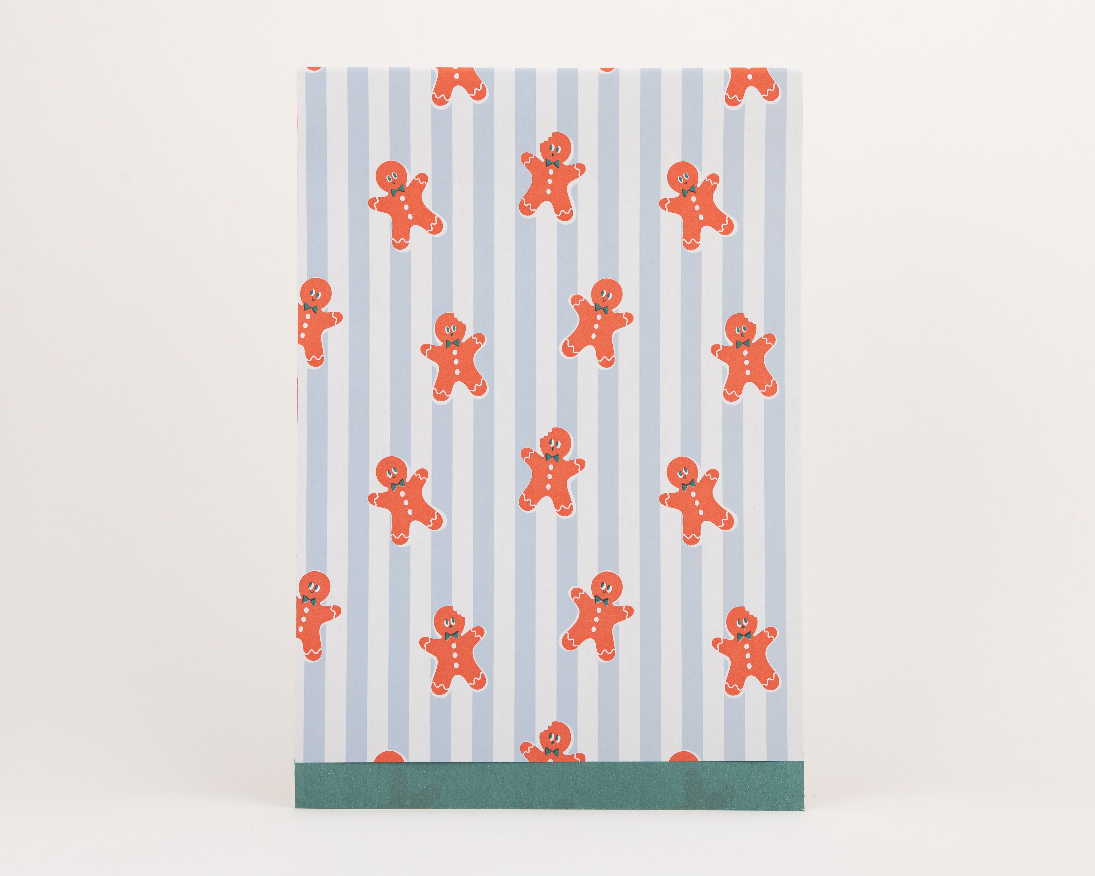 Papiertüten Flachbeutel zeigen ein blau gestreiftes Muster mit orangefarbenen Lebkuchenmännchen und kleinen grünen Schleifen, die Innenseite ist grün